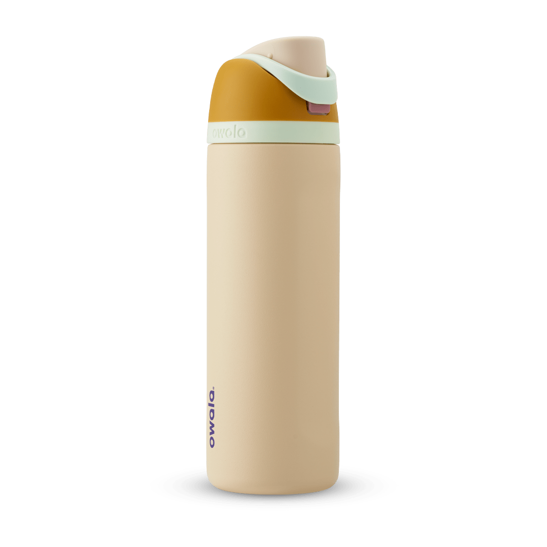 FreeSip 24oz in Water in the Desert, sand tan body with mustard yellow flip cap, mint green carry loop, and tan lid