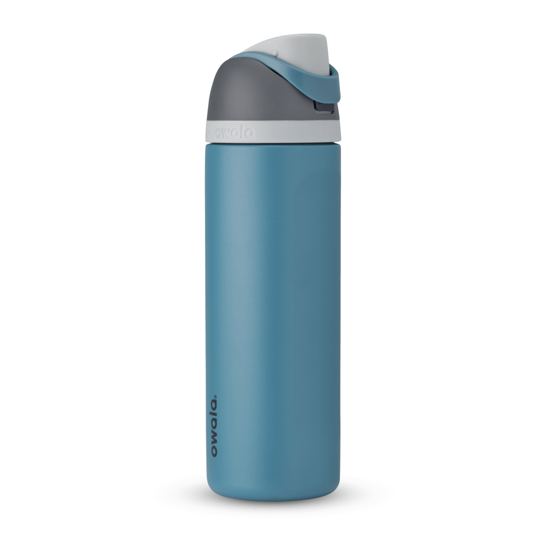 FreeSip 24oz in Blue Oasis, denim blue body with matching blue carry loop, dark gray flip cap, and white accent band