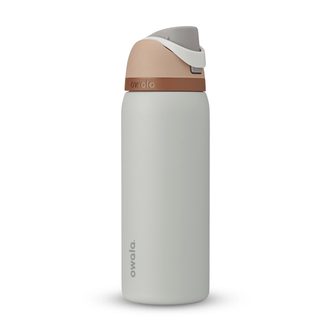 FreeSip 32oz in Calm Waters, pale gray body with peach flip cap, white carry loop, and copper accent band