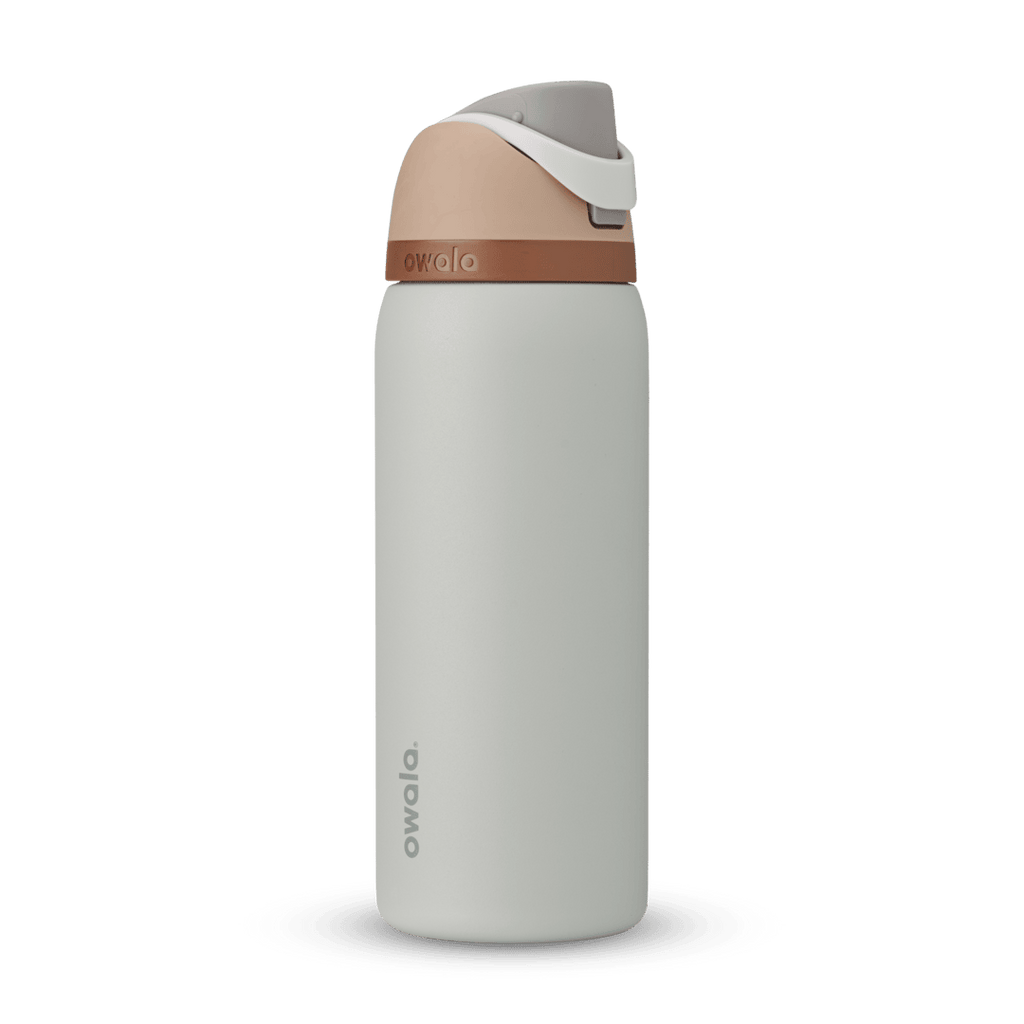 FreeSip 32oz water bottle, pale cool gray body with warm copper-tan band and blush top lid, flip cap