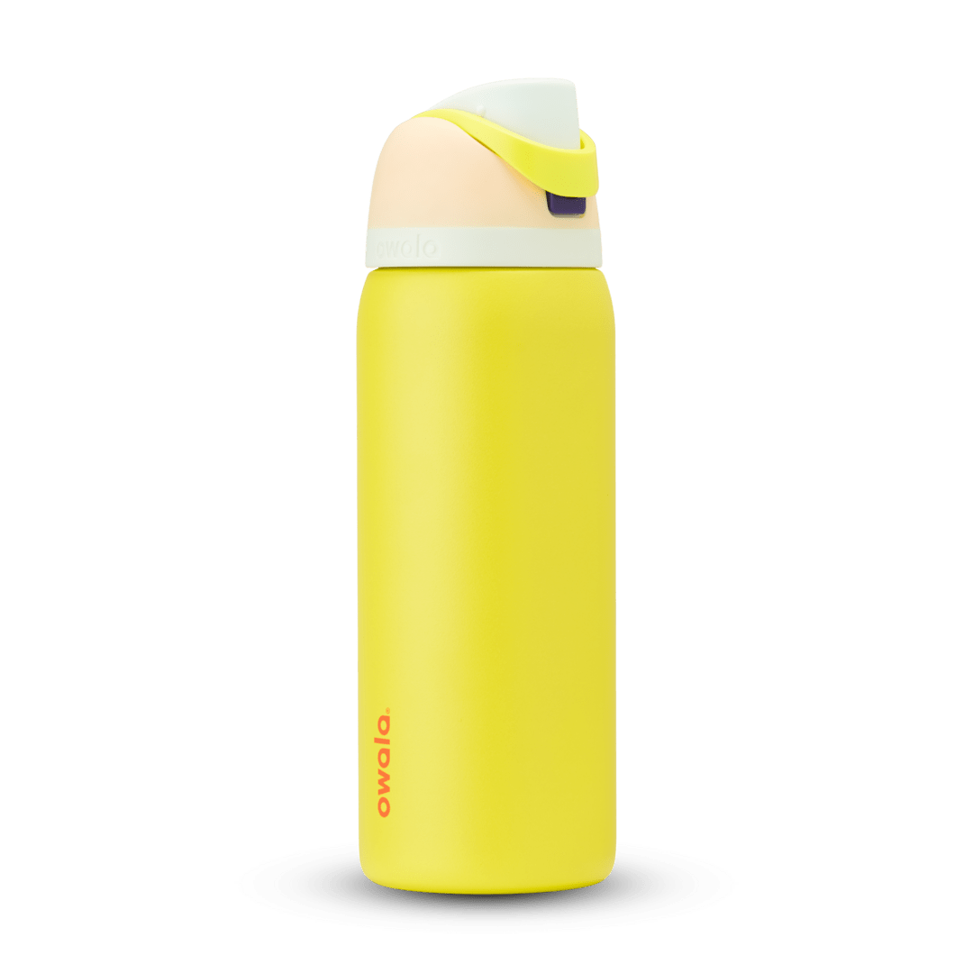 FreeSip 32oz in Lemon Limeade, bright yellow body with peach lid, neon yellow-green carry loop, white accent band, and orange logo