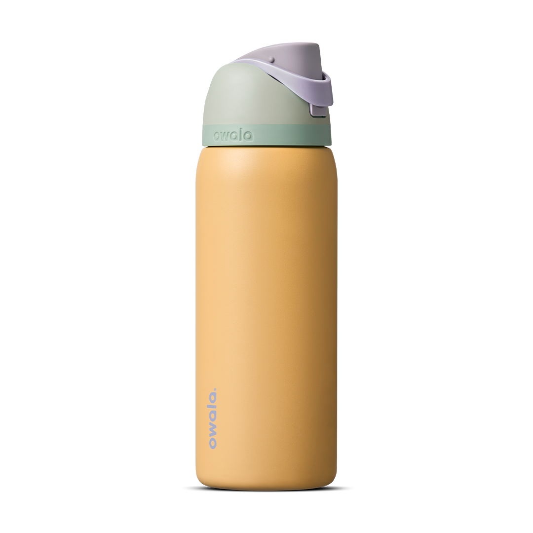FreeSip 32oz in Beachfront, warm golden yellow insulated bottle with mint green accent band, lavender flip cap, and lavender carry loop