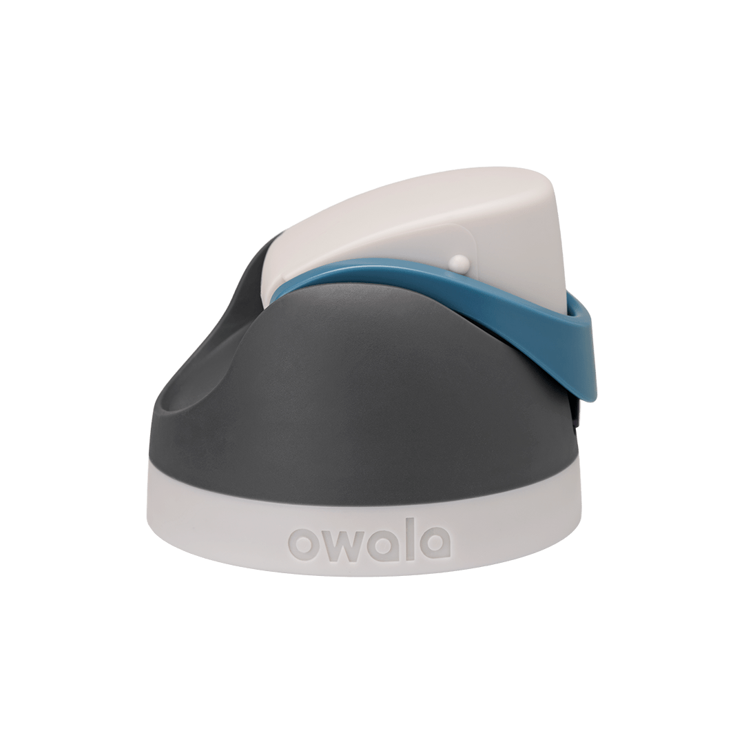 Owala FreeSip replacement lid in Blue Oasis, dark gray charcoal body with white flip cap, denim blue carry loop, and white base accent band