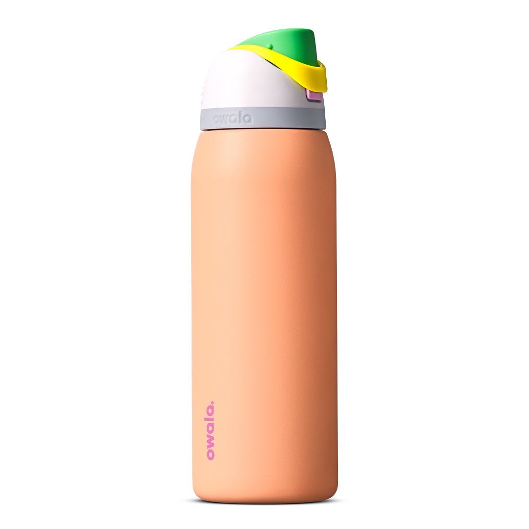 FreeSip 40oz in Peachy Keen, soft peach orange insulated bottle with white flip cap lid, yellow flip tab, and bright green carry loop