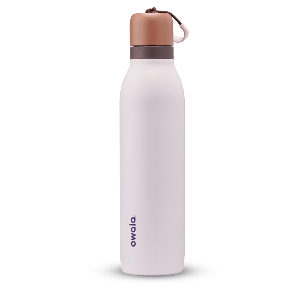 FreeSip Twist 24oz in Sleepy Lavender, soft pale lavender insulated water bottle with copper-orange twist cap, dark plum twist cap accent band, and pink carry string with brown grip