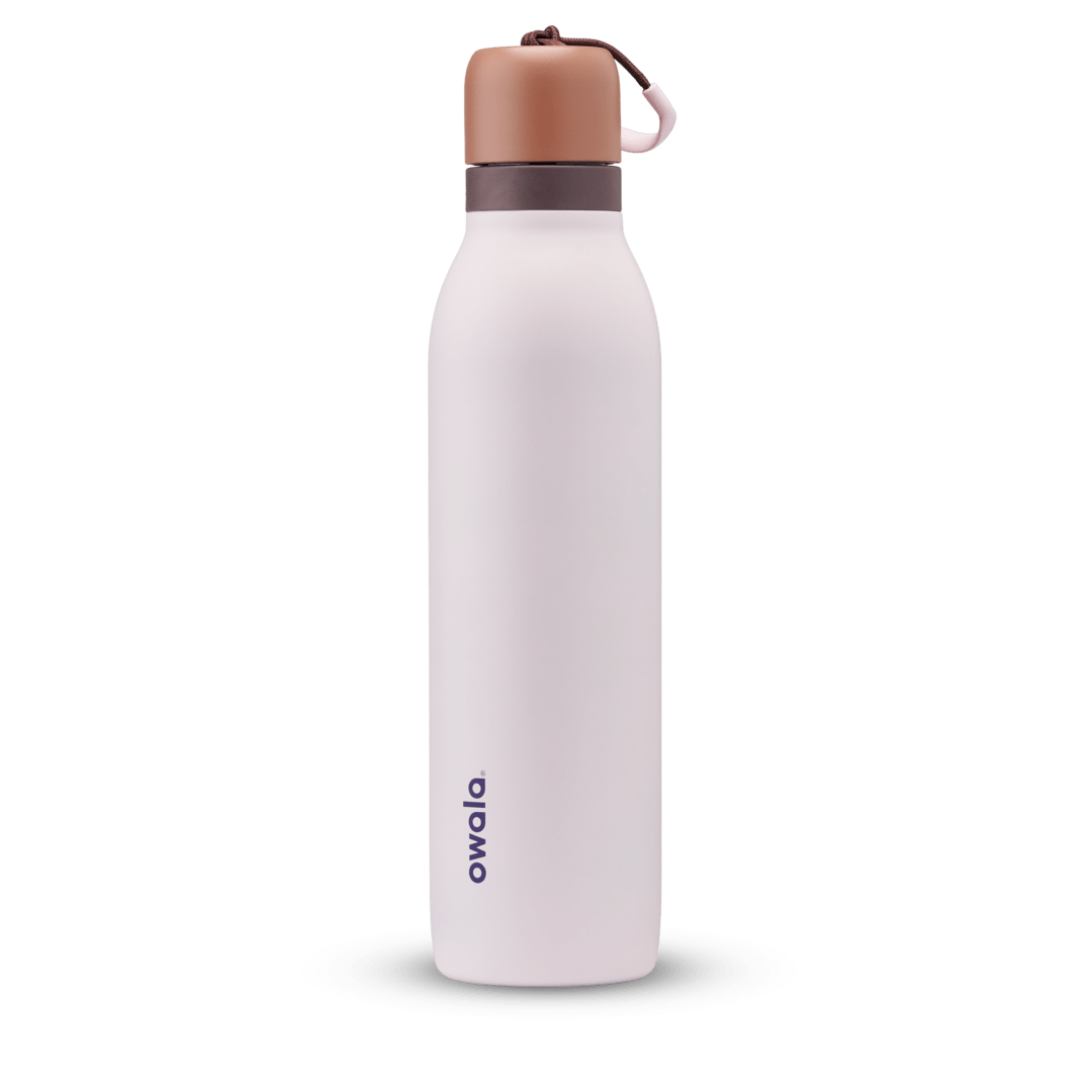 FreeSip Twist 24oz in Sleepy Lavender, soft pale lavender insulated water bottle with copper-orange twist cap, dark plum twist cap accent band, and pink carry string with brown grip