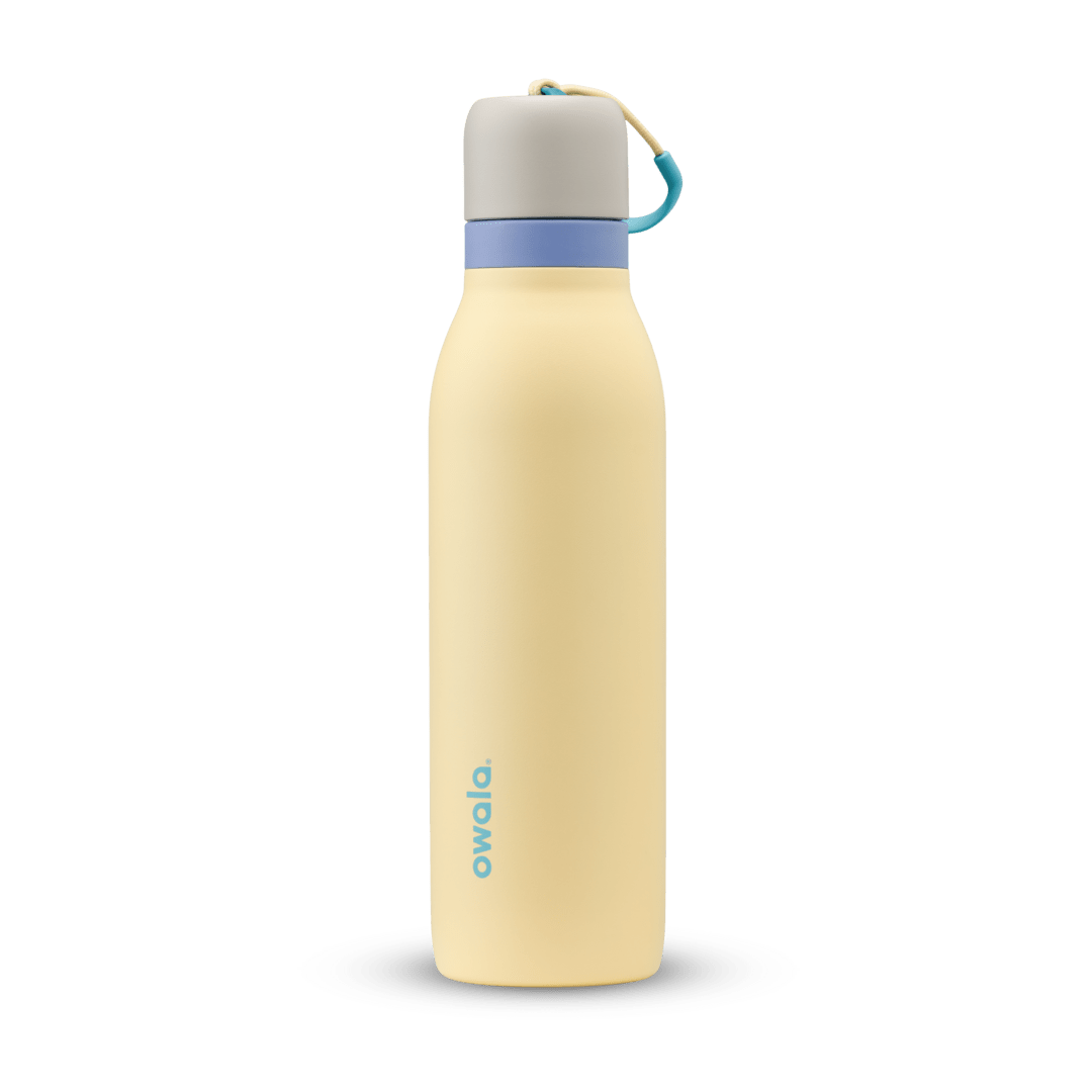 FreeSip Twist 18oz in Sunny Daze, pale yellow insulated water bottle with light gray twist cap, periwinkle blue twist cap accent band, and teal carry string with grip