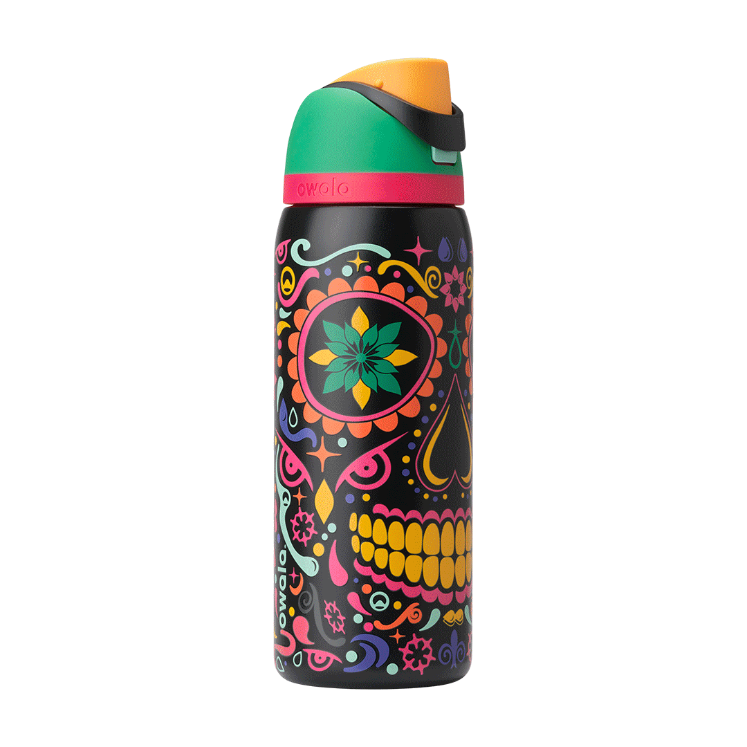 Rotating view of FreeSip in Sugar Skull, black body with colorful Day of the Dead sugar skull graphic in pink, yellow, green, and orange; green flip cap with orange detail and hot pink accent band on the lid; glows in the dark